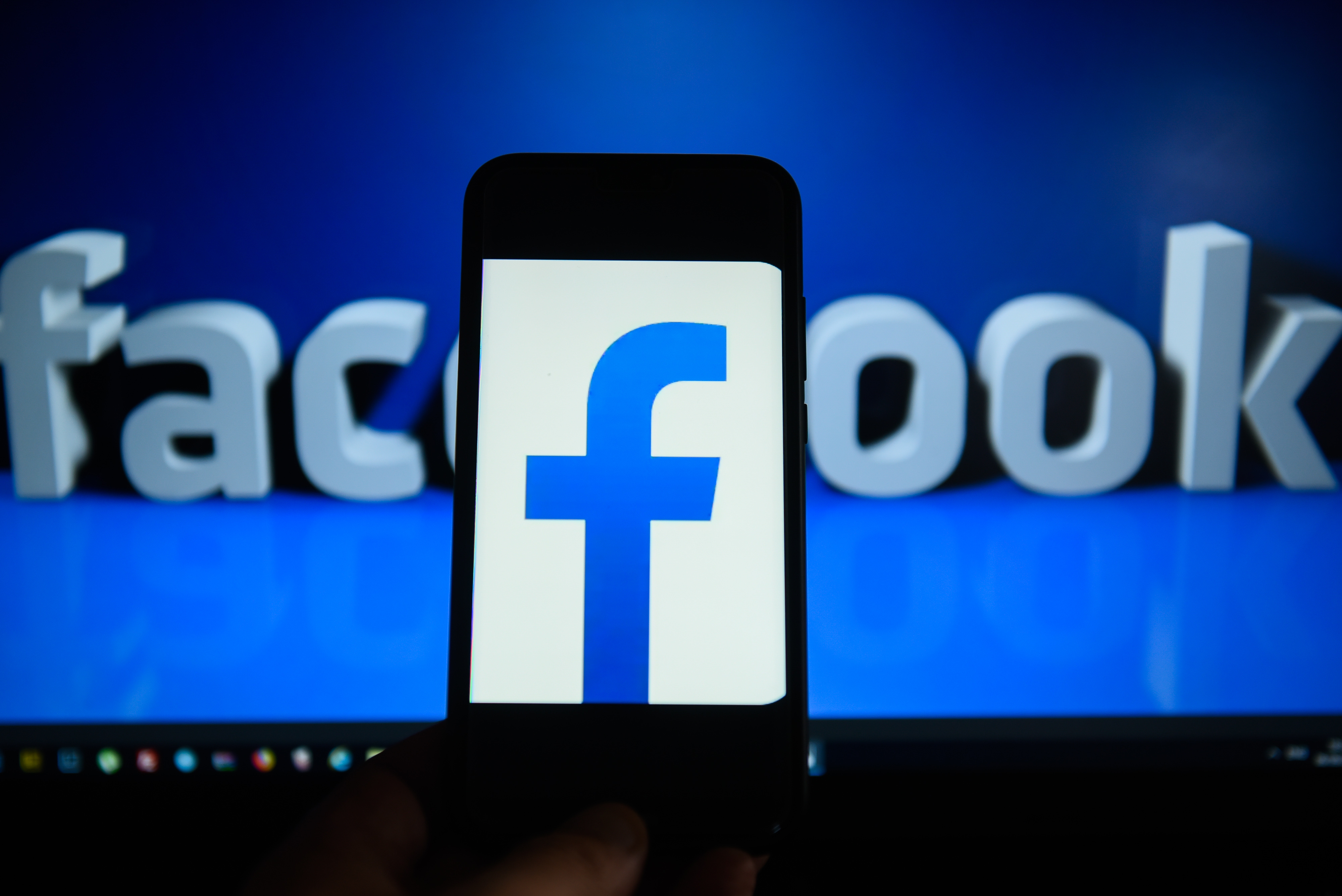 KRAKOW, POLAND - 2018/09/06: Facebook logo is seen on an android mobile phone in front of a computer screen with facebook sign. (Photo by Omar Marques/SOPA Images/LightRocket via Getty Images)