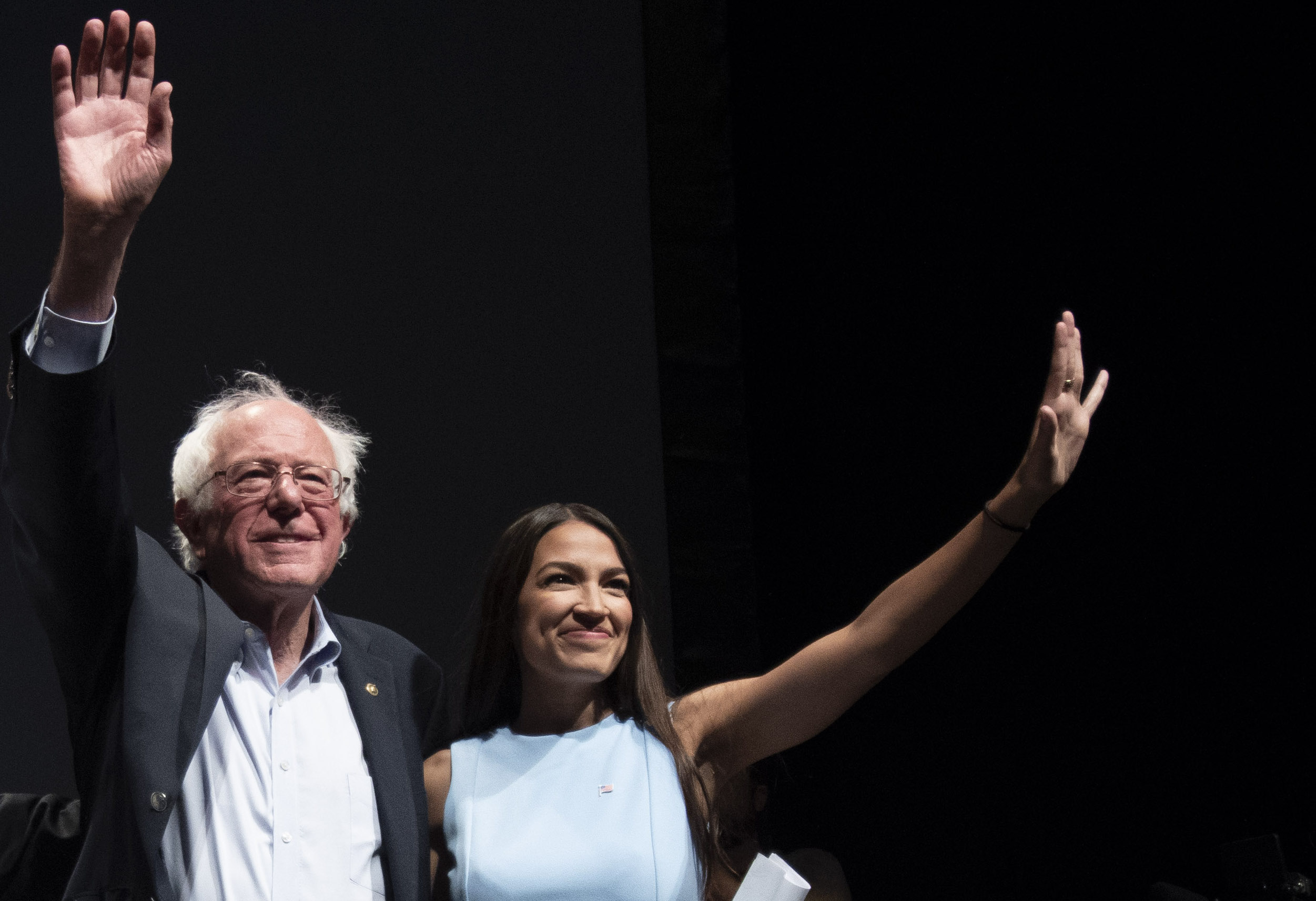 WICHITA, KA - JULY 20: James Thompson, Senator Bernie Sanders and Alexandria Ocasio-Cortez, wave to the crowd at the end of a campaign rally in Wichita, Kansas on July 20, 2018. (Photo by J Pat Carter for the Washington Post)