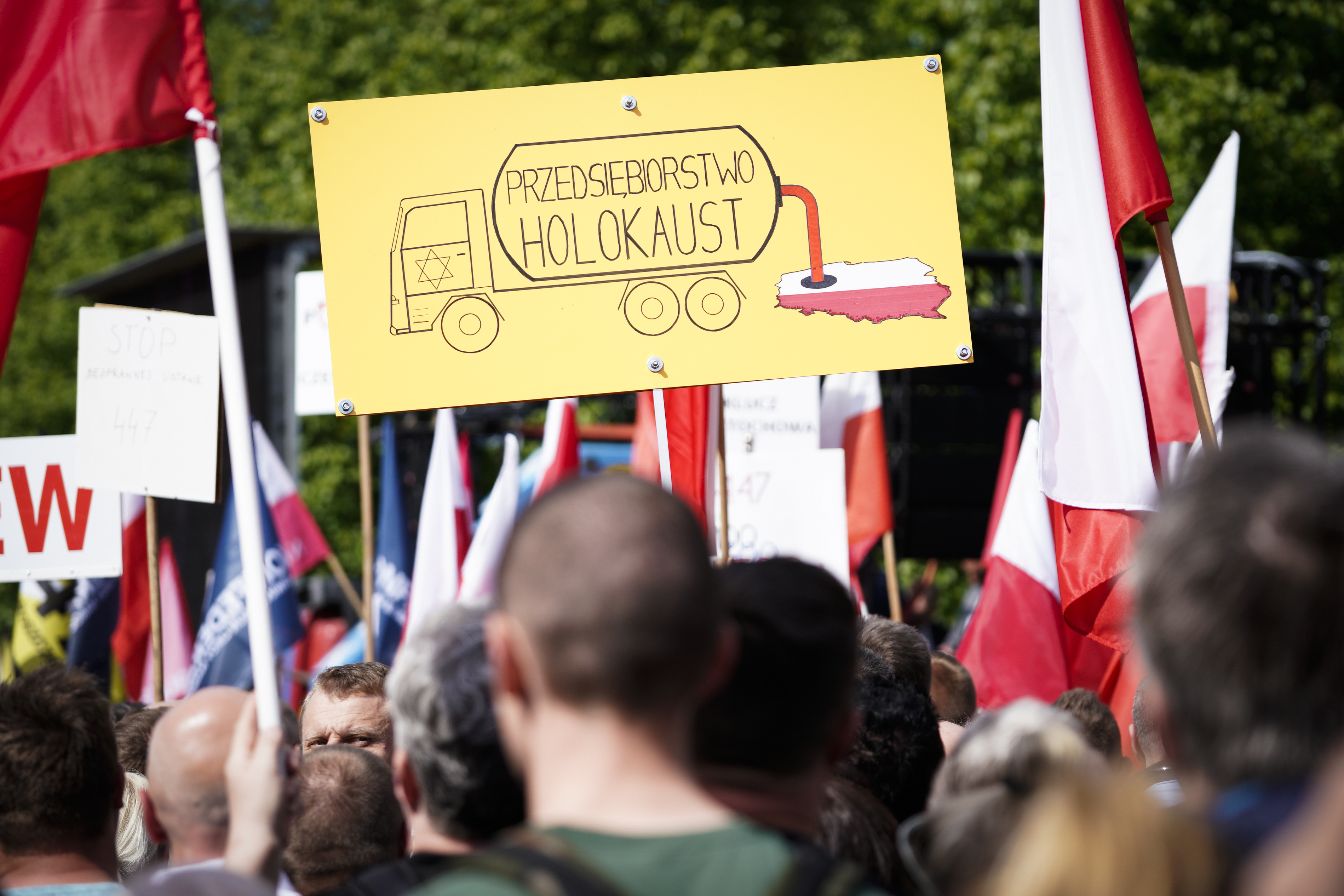 A sign is seen during the protest against the JUST act in Warsaw, Poland on May 11, 2019. Several thousand people gathered in front of the Prime Minister's office and marched to the US embassy to protest the Justice for Uncompensated Survivors Today (JUST) act 447 which requires the US State Department to report on progress made by 47 countries on compensation of assests seized during WWII for Holocaust survivors. Poland is the only European country that has not yet passed any laws to regulate compensation for rightful owners of seized properties. (Photo by Jaap Arriens/NurPhoto)
