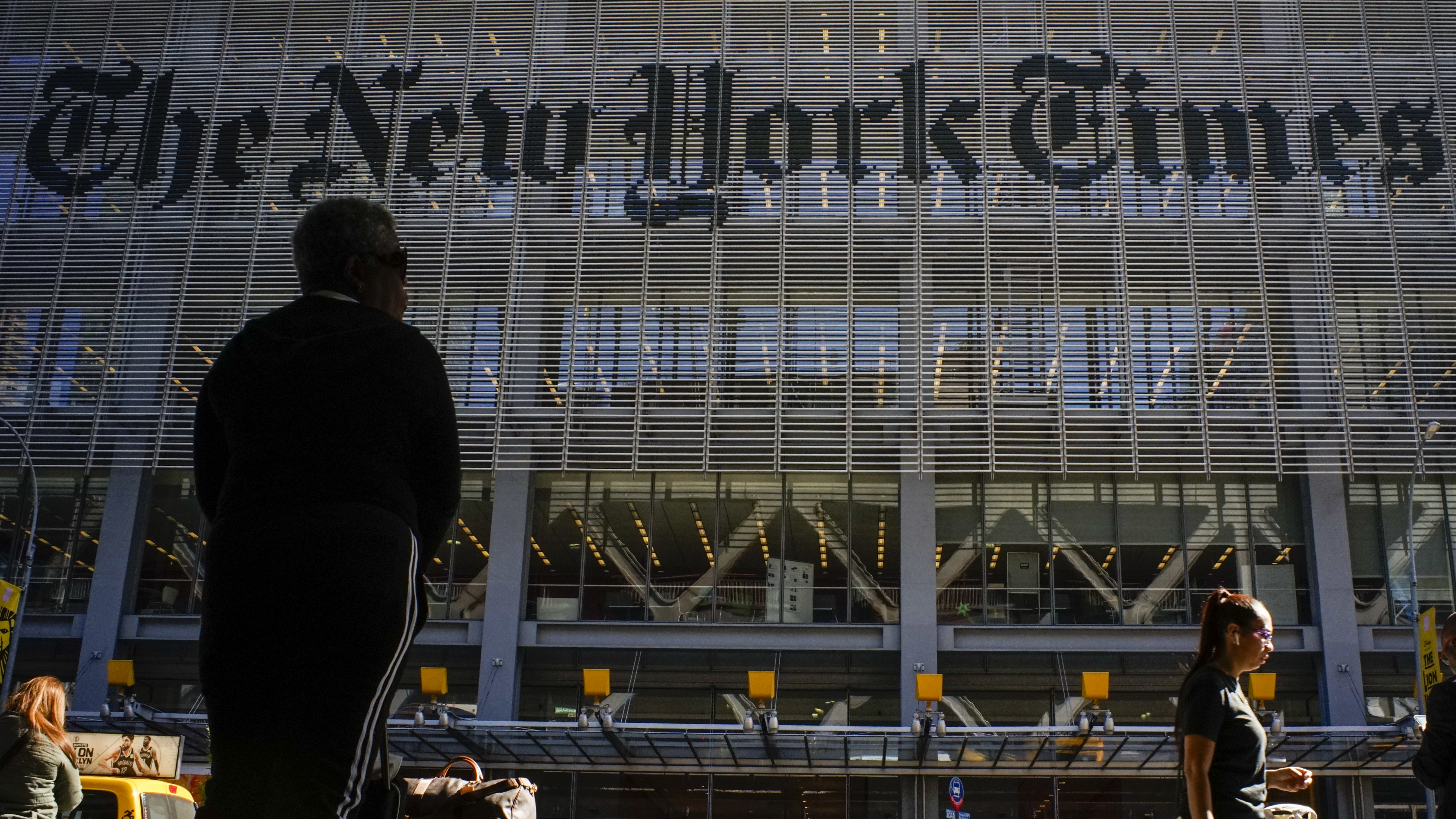 NEW YORK, USA - October 14: People walk along 8av as the New York Times building is seen at the background on October 14, 2019 in New York, USA. NY Times on Sunday evening, published a story titled, "Macabre Video of Fake Trump Shooting Media and Critics Is Shown at His Resort." The video showed the president as a mass shooter where he is executing media and his political opponents inside church. It was dysplayed at a pro Trump conference in Miami. NY Times is an American newspaper based in New York City with worldwide influence,  the paper has won 127 Pulitzer Prizes,  being ranked 18th in the world by circulation.(Photo by Eduardo MunozAlvarez/VIEWpress/Corbis via Getty Images)