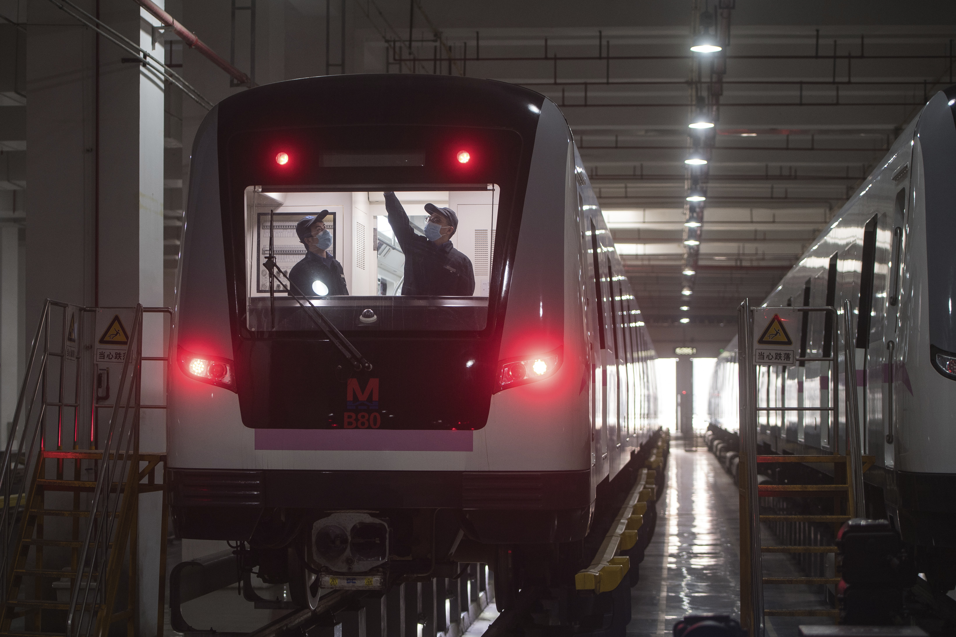 In this March 23, 2020 photo released by Xinhua News Agency, workers prepares a subway train for restoration of public transport in Wuhan, in central China's Hubei province. China's health ministry says Wuhan has now gone several consecutive days without a new infection, showing the effectiveness of draconian travel restrictions that are slowly being relaxed around the country. (Xiao Yijiu/Xinhua via AP)
