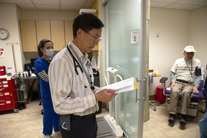 SEATTLE, WA - MARCH 20: Dr. Alan Chun checks on a patient who suffered a fall at the International Community Health Services’ medical clinic in their assisted living facilty, the Legacy House, on March 20, 2020 in Seattle, Washington. The International Community Health Services is a non-profit clinic that cares for uninsured patients, low income people and immigrants, many of whom rely on federal aid programs. Non-profit community health centers around the country are facing the expiration of federal funding in May as the coronavirus (COVID-19) continues to spread. (Photo by Karen Ducey/Getty Images)