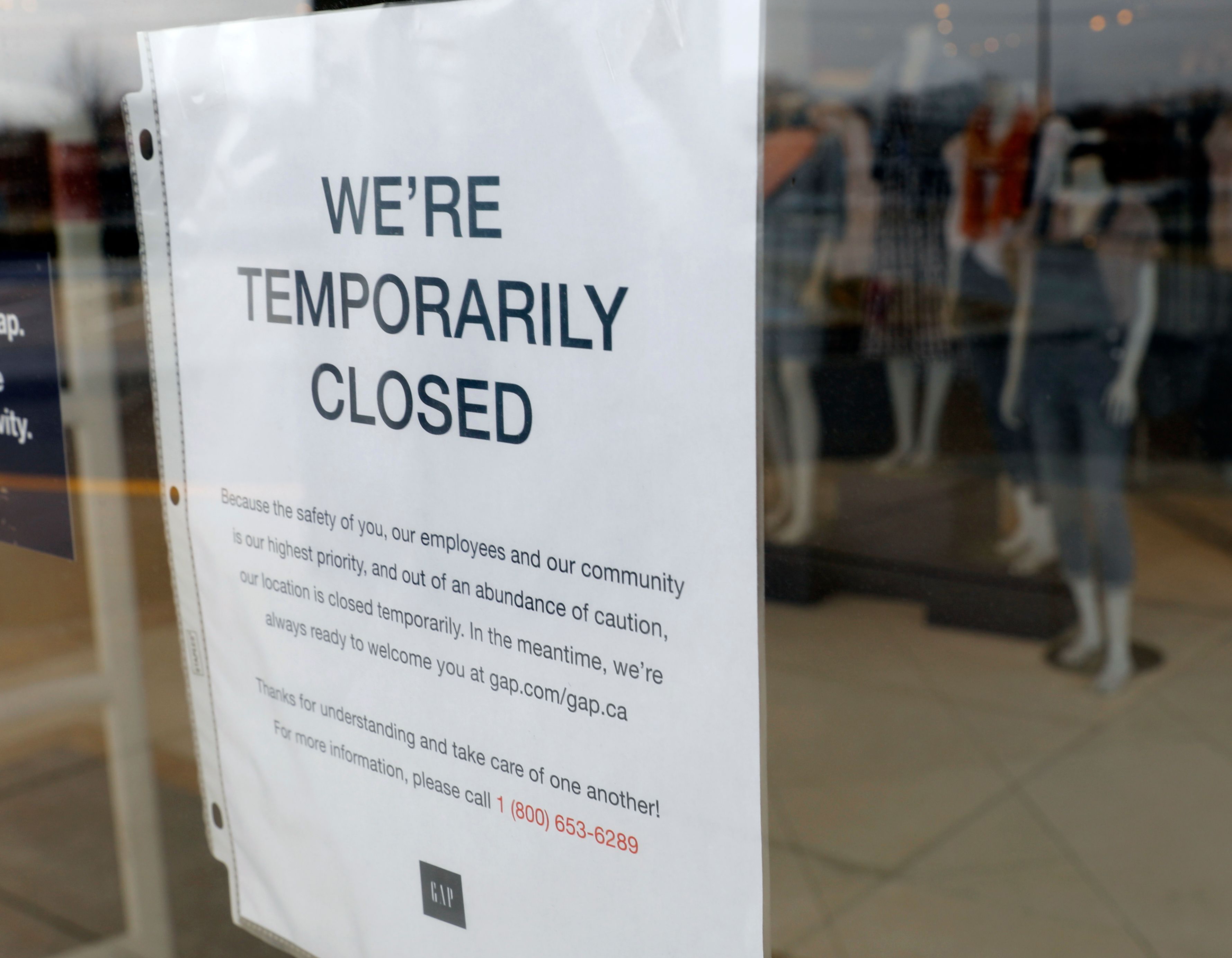 A GAP store with a Closed sign due to the COVID-19 outbreak in Farmington Hills, Michigan, on March 26, 2020. - The economic shutdown caused by the coronavirus pandemic sparked an explosion of Americans filing for unemployment benefits, surging to 3.3 million last week -- the highest number ever recorded, the Labor Department reported Thursday. (Photo by JEFF KOWALSKY / AFP) (Photo by JEFF KOWALSKY/AFP via Getty Images)