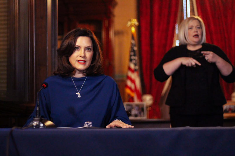 In a pool photo provided by the Michigan Office of the Governor, Gov. Gretchen Whitmer addresses the state during a speech in Lansing, Mich., Monday, March 30, 2020. The governor said she suspended state hiring and promotions and vetoed $80 million in new spending in order to steer money to fighting the coronavirus. At the same time, Whitmer said she signed laws with $150 million for the state's response. She said it's too early to know how the economic slowdown related to the virus will affect state revenue but the impact "is going to be real.” (Michigan Office of the Governor via AP, Pool)