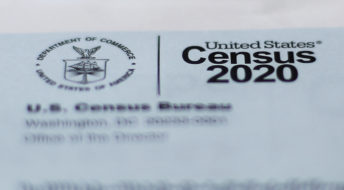 A 2020 census letter mailed to a U.S. resident, is shown in Detroit, Sunday, April 5, 2020. The Census Bureau is required by federal statute to send the president the counts that will be used to carve up congressional districts — known as apportionment — and draw state legislative districts by Dec. 31. The new coronavirus COVID-19 spread forced the U.S. Census Bureau to suspend field operations (AP Photo/Paul Sancya)
