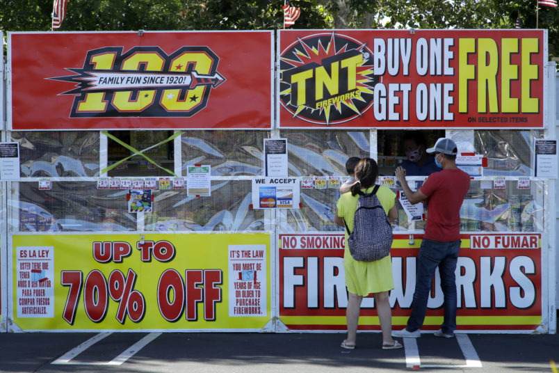People purchase fireworks on Thursday, July 2, 2020, in Dublin, Calif. (AP Photo/Ben Margot)