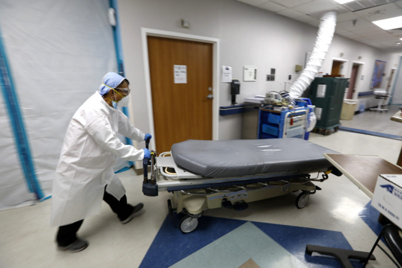 HOUSTON, TEXAS—JULY 1, 2020—An empty bed is moved back to the emergency room after brining in another COVID-19 patient. At United Memorial Medical Center in Houston, Texas, Dr. Joseph Varon leads a team to fight the increasing number of coronavirus patients in the expanded Covid-19 ward on July 1, 2020. (Carolyn Cole/Los Angeles Times)