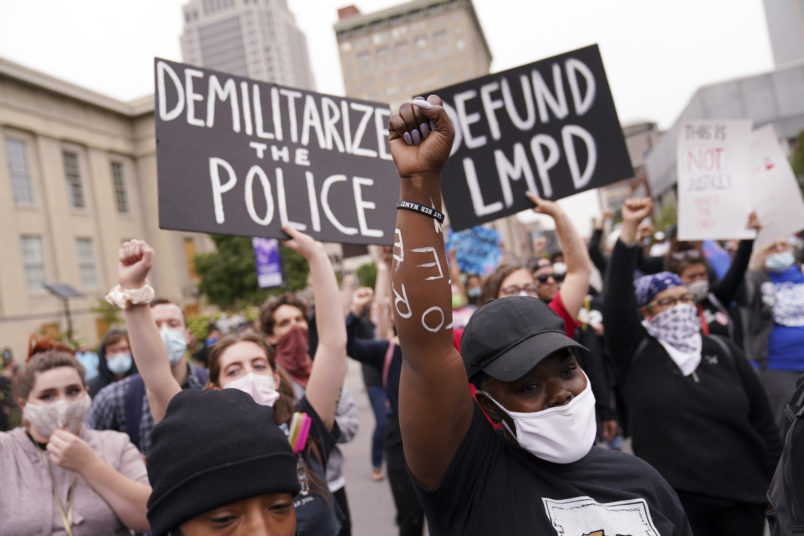 Protesters speak, Wednesday, Sept. 23, 2020, in Louisville, Ky. A grand jury has indicted one officer on criminal charges six months after Breonna Taylor was fatally shot by police in Kentucky. The jury presented its decision against fired officer Brett Hankison Wednesday to a judge in Louisville, where the shooting took place. (AP Photo/John Minchillo)