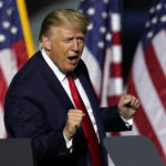 President Trump does a little dance as he leaves the stage during an airport rally Friday, Sept. 25, 2020, in Newport News, Va. (AP Photo/Steve Helber)