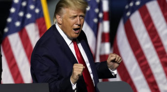 President Trump does a little dance as he leaves the stage during an airport rally Friday, Sept. 25, 2020, in Newport News, Va. (AP Photo/Steve Helber)