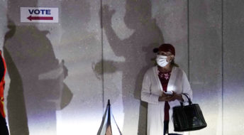 A woman waits to vote, Monday, Oct. 19, 2020, in Miami. Florida begins in-person early voting in much of the state Monday. With its 29 electoral votes, Florida is crucial to both candidates in order to win the White House. (AP Photo/Lynne Sladky)