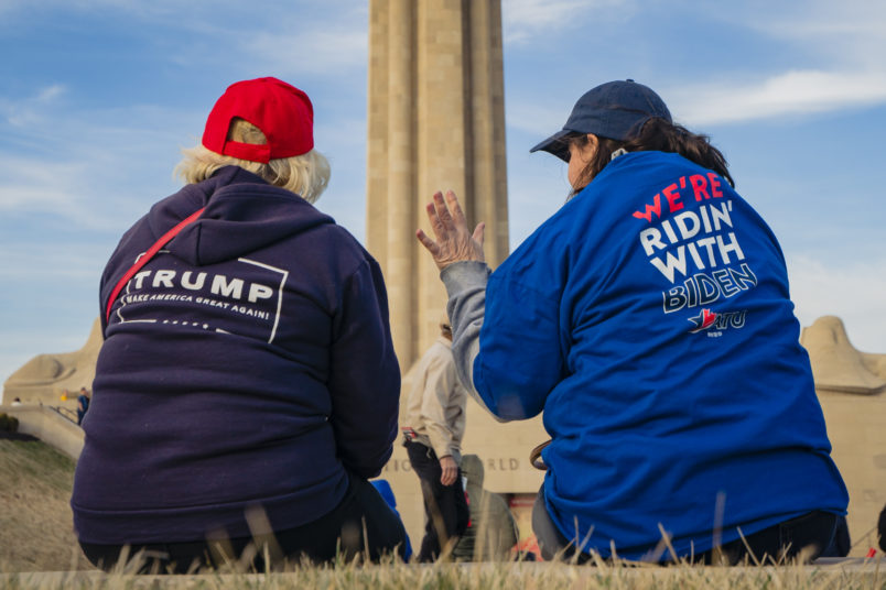 KANSAS CITY, MO - MARCH 07: A President Donald Trump and a former Vice President Joe Biden supporter converse before the Joe Biden Campaign Rally at the National World War I Museum and Memorial on March 7, 2020 in Kansas City, Missouri. (Photo by Kyle Rivas/Getty Images)