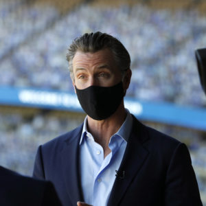 Los Angeles, California—Oct. 30, 2020—Gov. Gavin Newsom talks to the media after visiting Dodger Stadium on Oct. 30, 2020. (Carolyn Cole/ Los Angeles Times)