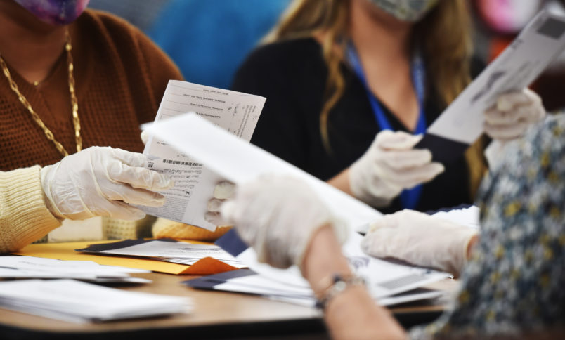 WILKES-BARRE, UNITED STATES - 2020/11/04: Luzerne County employees open mail-in ballots to be counted at the elections board in Wilkes-Barre.Pennsylvania mail-in ballots are being counted with about fifty thousand in total, Luzerne County hopes to finish tonight. Media is allowed to document the vote counting process in Pennsylvania. (Photo by Aimee Dilger/SOPA Images/LightRocket via Getty Images)