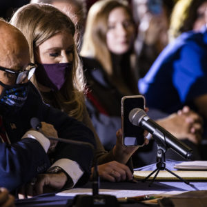 GETTYSBURG, PA - NOVEMBER 25: Jenna Ellis, a member of President Donald Trumps legal team, holds up a cell phone to the microphone so President Trump can speak during a Pennsylvania Senate Majority Policy Committee public hearing Wednesday at the Wyndham Gettysburg hotel to discuss 2020 election issues and irregularities on November 25, 2020 in Gettysburg, Pennsylvania. Giuliani is continuing his push to over turn election results in the courts. (Photo by Samuel Corum/Getty Images) *** Local Caption *** Jenna Ellis; Rudy Giuliani