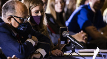 GETTYSBURG, PA - NOVEMBER 25: Jenna Ellis, a member of President Donald Trumps legal team, holds up a cell phone to the microphone so President Trump can speak during a Pennsylvania Senate Majority Policy Committee public hearing Wednesday at the Wyndham Gettysburg hotel to discuss 2020 election issues and irregularities on November 25, 2020 in Gettysburg, Pennsylvania. Giuliani is continuing his push to over turn election results in the courts. (Photo by Samuel Corum/Getty Images) *** Local Caption *** Jenna Ellis; Rudy Giuliani