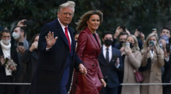 President Donald Trump and first lady Melania Trump walk on the South Lawn of the White House in Washington, Saturday, Dec. 5, 2020, before boarding Marine One for a short trip to Andrews Air Force Base, Md. Trump is en route to Georgia for a rally for U.S. Senate candidates David Perdue and Kelly Loeffler. (AP Photo/Patrick Semansky)