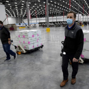 Boxes containing the Moderna COVID-19 vaccine are prepared to be shipped at the McKesson distribution center in Olive Branch, Miss., Sunday, Dec. 20. (AP Photo/Paul Sancya, Pool)