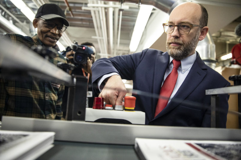 WASHINGTON, DC - FEBRUARY 06: Acting Director of the Office of Management and Budget Russ Vought presses the button that starts the machine that will print copies of President Donald Trumps proposed budget for the U.S. Government for the 2021 Fiscal Year are printed at the Government Publishing Office ahead of its release next week on February 6, 2020 in Washington, DC. Once released, the budget will be debated in Congress before it becomes official. (Photo by Samuel Corum/Getty Images) *** Local Caption *** Russ Vought