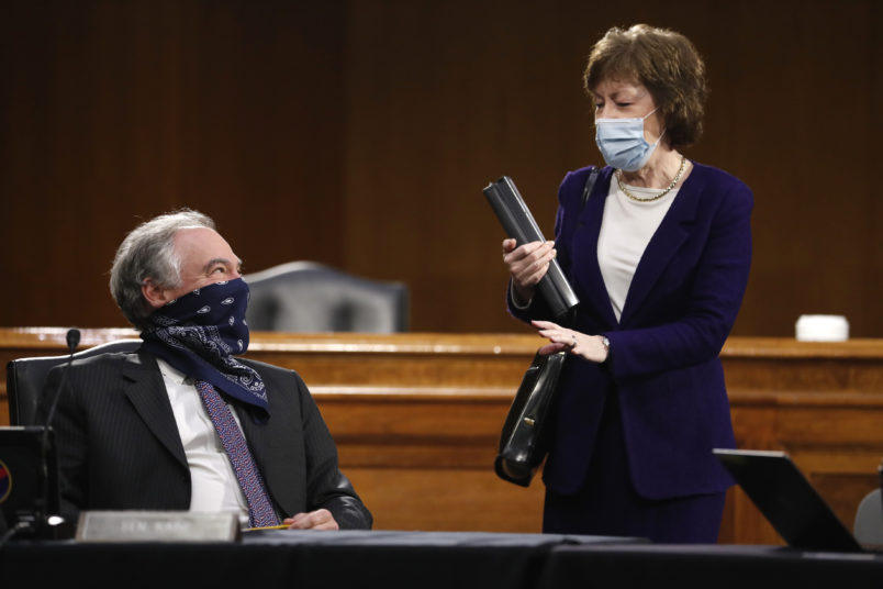 Sen. Tim Kaine, D-Va., speaks with Sen. Susan Collins, R-Maine, before a Senate Health Education Labor and Pensions Committee hearing on new coronavirus tests on Capitol Hill in Washington, Thursday, May 7, 2020. (AP Photo/Andrew Harnik, Pool)