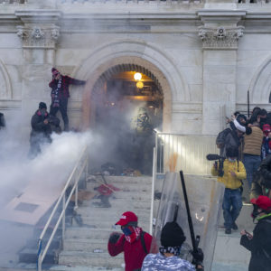 WASHINGTON DC, DISTRICT OF COLUMBIA, UNITED STATES - 2021/01/06: Police use tear gas around Capitol building where pro-Trump supporters riot and breached the Capitol. Rioters broke windows and breached the Capitol building in an attempt to overthrow the results of the 2020 election. Police used batons and tear gas grenades to eventually disperse the crowd. Rioters used metal bars and tear gas as well against the police. (Photo by Lev Radin/Pacific Press/LightRocket via Getty Images)