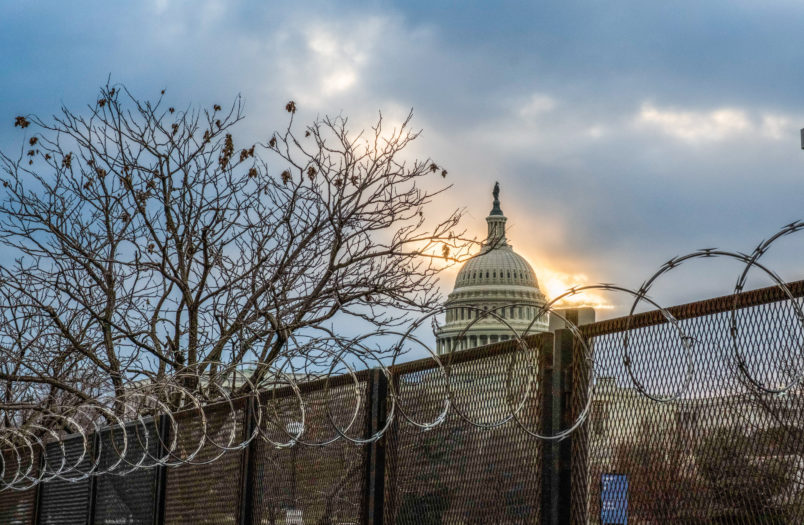 WASHINGTON, DISTRICT OF COLUMBIA, UNITED STATES - 2021/01/23: Razor wire and fences still surround the United States Capitol building at sunrise a few days after the inauguration of President Joe Biden and Vice President Kamala Harris. The Capitol was breached during an insurrection January 6 just days before the inauguration. (Photo by Jeremy Hogan/SOPA Images/LightRocket via Getty Images)