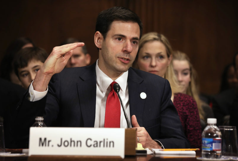 WASHINGTON, DC - JANUARY 08: Acting Assistant Attorney General for National Security at the Department of Justice John Carlin testifies as his wife Sarah listens during his confirmation hearing before the Senate Judiciary Committee January 8, 2014 on Capitol Hill in Washington, DC. Carlin has been nominated by President Barack Obama to become the next Assistant Attorney General for National Security at the Department of Justice. (Photo by Alex Wong/Getty Images)