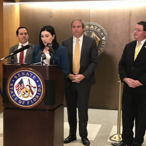 Laura Loomer speaks about a bill that seeks to stop social media censorship, on Tuesday, Jan. 21, 2020, in Tallahassee, Fla. Standing behind Loomer, from left, are state Rep. Anthony Sabatini (R-Fla.), Republican state Sen. Joe Gruters and Republican state Rep. Randy Fine. (Skyler Swisher/Sun Sentinel/TNS)