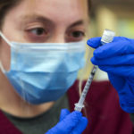 Los Angeles , CA - May 14: Alma Sevilla preparers Pfizer COVID-19 vaccine vial at a mobile vaccine clinic held at Roosevelt Park on Friday, May 14, 2021 in Los Angeles , CA. (Irfan Khan / Los Angeles Times)